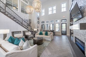 A living room with a staircase and a fireplace.